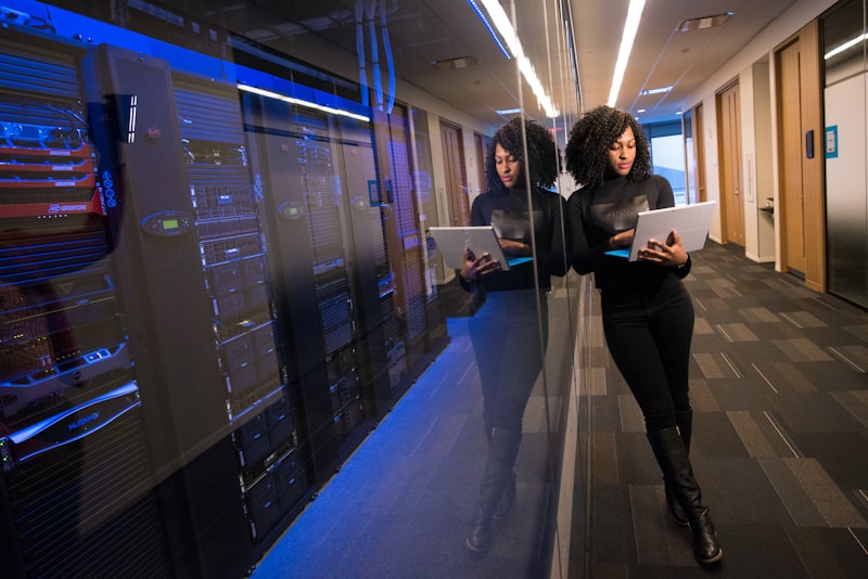 Two professionals reviewing data in a server room
