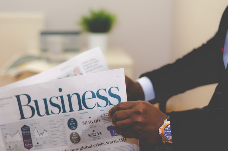 Businessperson reading a newspaper business section